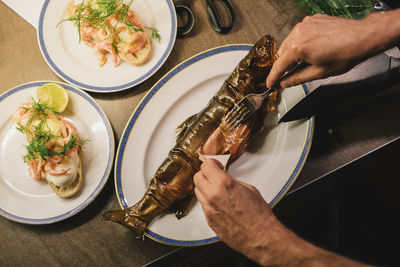 High angle view of hand holding food on table