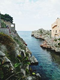 Scenic view of sea and buildings against sky