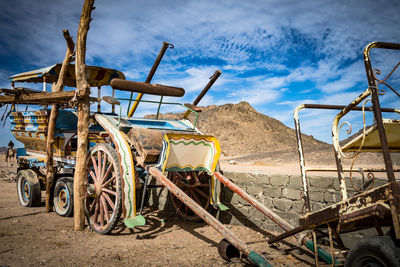 View of old machinery on land against sky