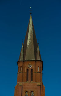 Low angle view of building against clear blue sky