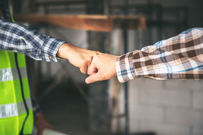 Midsection of man holding hands