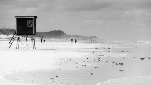 Scenic view of beach against sky during winter