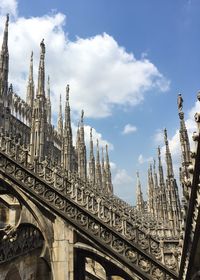 Low angle view of milan cathedral against cloudy sky