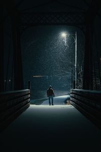 A man standing while it's snowing