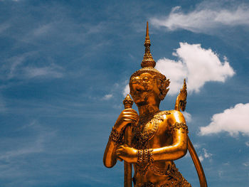 Low angle view of statue against temple against sky