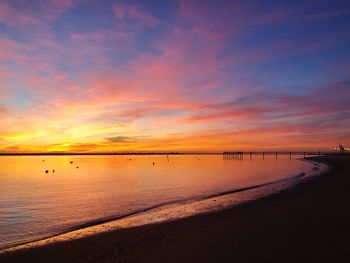 Scenic view of beach against sky during sunset