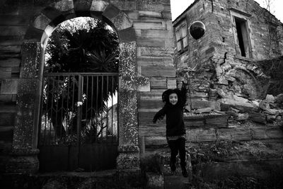 Portrait of man standing against built structure