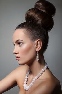 Close-up of beautiful fashion model against gray background