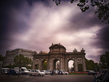 View of cityscape against cloudy sky