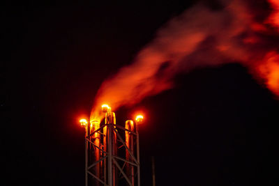 Low angle view of illuminated light against sky at night