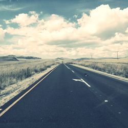 Road by landscape against sky