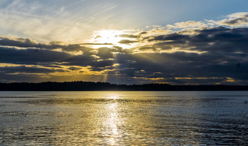 A view of clouds with ray of light shining through over the puget sound.