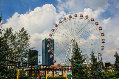 Low angle view of ferris wheel against sky