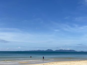 People on beach against sky