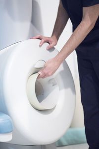 Midsection of man standing by mri scanner