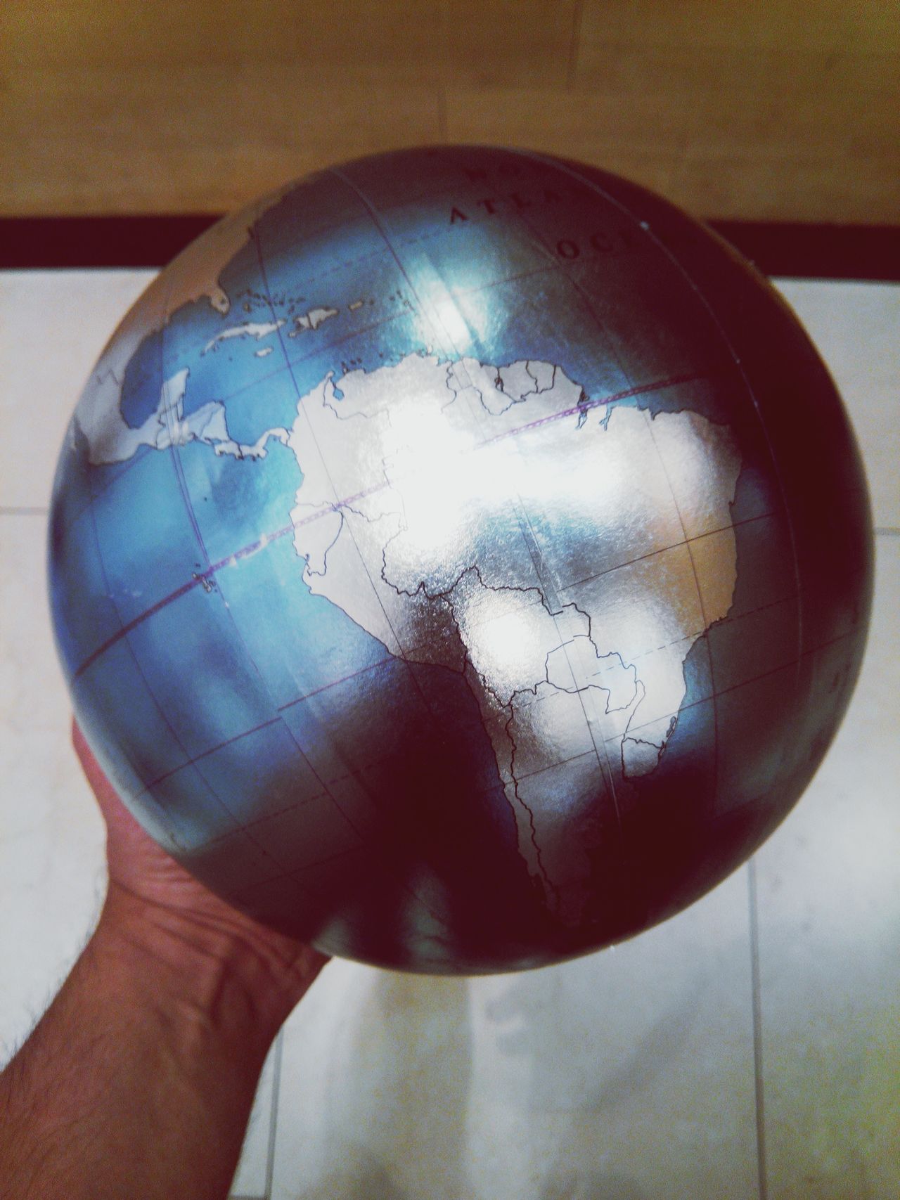 Hand holding a globe