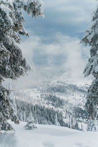 Scenic view of snow covered landscape against sky
