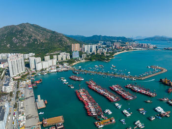 High angle view of townscape by sea against sky