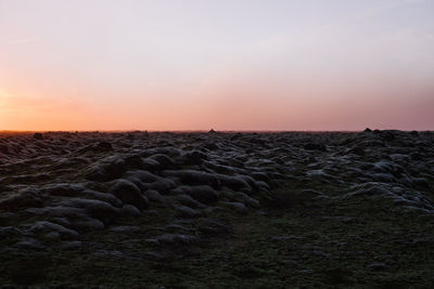 Scenic view of land against sky during sunset