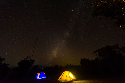 Illuminated tent against sky at night
