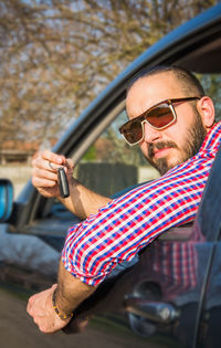 Close-up portrait of man in car