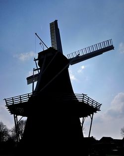 Low angle view of traditional windmill against sky