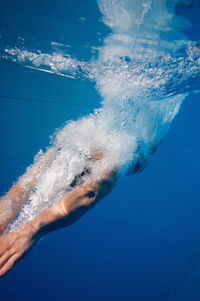 Mid adult woman swimming in pool