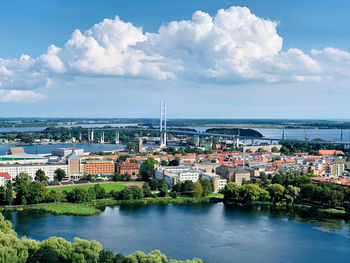 River amidst buildings in city against sky