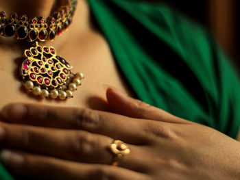 Cropped hand of woman with henna tattoo