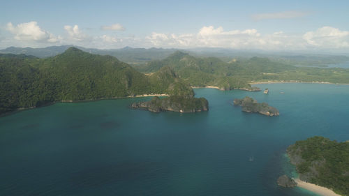 High angle view of sea and mountains against sky