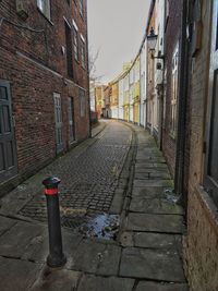 Narrow street amidst buildings in city