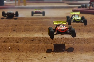 Remote controlled cars racing outdoors