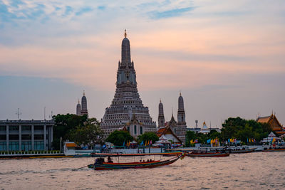 View of temple on building against cloudy sky