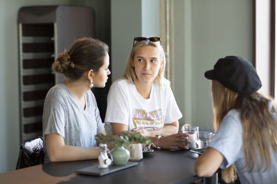 Female friends talking in cafe