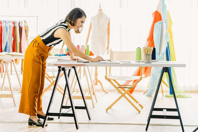 Woman standing on table at home