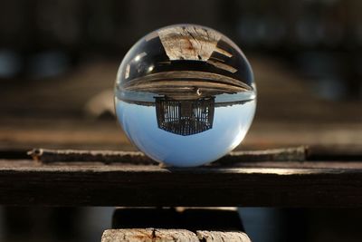 Pier and stilt house reflecting on crystal ball