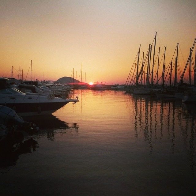 sunset, water, nautical vessel, transportation, boat, orange color, mode of transport, moored, waterfront, reflection, sea, mast, silhouette, tranquil scene, sailboat, tranquility, harbor, scenics, beauty in nature, clear sky