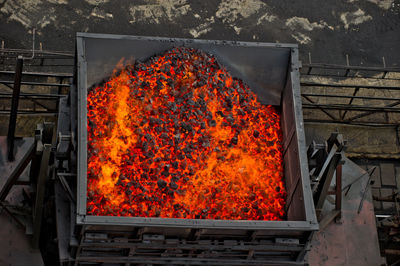 High angle view of burning charcoal in coal mine