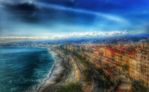 Aerial view of cityscape by sea against sky