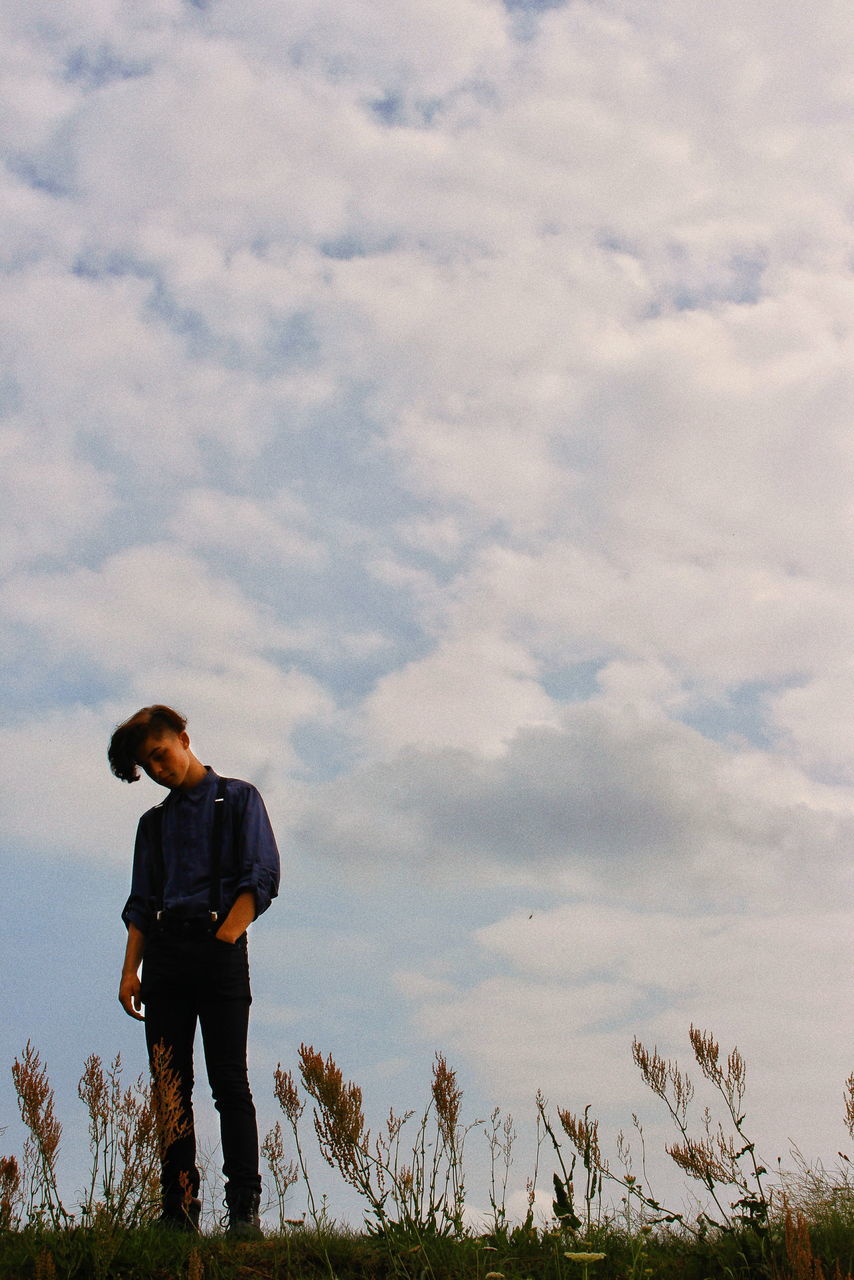 cloud - sky, sky, one person, standing, real people, outdoors, leisure activity, full length, low angle view, nature, lifestyles, casual clothing, rear view, men, day, adventure, scenics, landscape, beauty in nature, tree, people