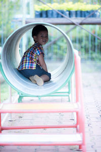 Portrait of cute boy sitting outdoors