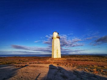 Windmill on field against sky