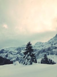 Scenic view of snow covered mountains against sky