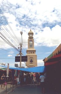 People against cloudy sky
