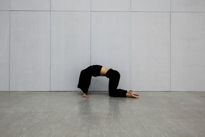 Full length of senior man kneeling on floor