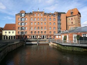 Bridge over canal amidst buildings in city