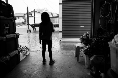 Woman walking on sidewalk in city