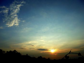 Silhouette trees against sky during sunset