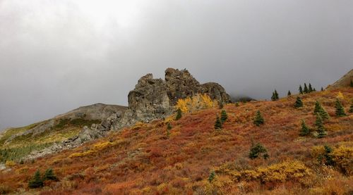 Low angle view of rocky mountain against sky