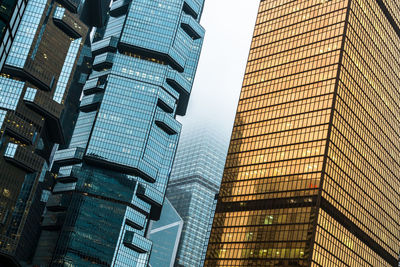 Low angle view of modern buildings against sky in city